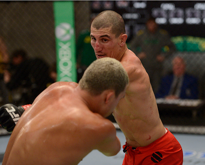 LACHUTE, CANADA - NOVEMBER 11: (R-L) Team Canada fighter Nordine Taleb punches Team Australia fighter Tyler Manawaroa in their middleweight fight during filming of The Ultimate Fighter Nations television series on November 11, 2013 in Lachute, Quebec, Ca