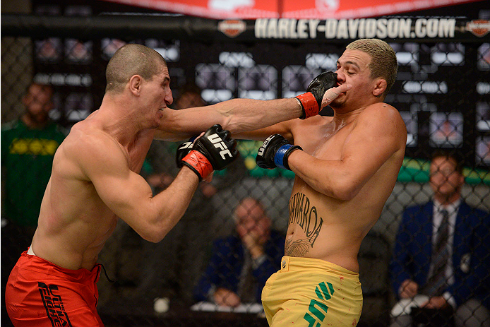 LACHUTE, CANADA - NOVEMBER 11: (L-R) Team Canada fighter Nordine Taleb punches Team Australia fighter Tyler Manawaroa in their middleweight fight during filming of The Ultimate Fighter Nations television series on November 11, 2013 in Lachute, Quebec, Ca