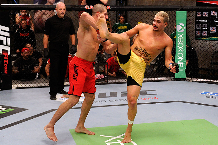 LACHUTE, CANADA - NOVEMBER 11: (R-L) Team Australia fighter Tyler Manawaroa kicks Team Canada fighter Nordine Taleb in their middleweight fight during filming of The Ultimate Fighter Nations television series on November 11, 2013 in Lachute, Quebec, Cana