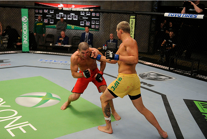 LACHUTE, CANADA - NOVEMBER 11: (R-L) Team Australia fighter Tyler Manawaroa punches Team Canada fighter Nordine Taleb in their middleweight fight during filming of The Ultimate Fighter Nations television series on November 11, 2013 in Lachute, Quebec, Ca