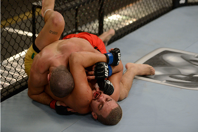 LACHUTE, CANADA - NOVEMBER 11: (L-R) Team Canada fighter Nordine Taleb takes down Team Australia fighter Tyler Manawaroa in their middleweight fight during filming of The Ultimate Fighter Nations television series on November 11, 2013 in Lachute, Quebec,