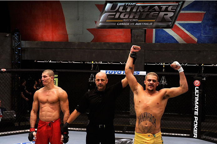 LACHUTE, CANADA - NOVEMBER 11: (R-L)Team Australia fighter Tyler Manawaroa celebrates after defeating Team Canada fighter Nordine Taleb in their middleweight fight during filming of The Ultimate Fighter Nations television series on November 11, 2013 in L