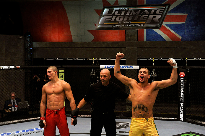 LACHUTE, CANADA - NOVEMBER 11: (R-L)Team Australia fighter Tyler Manawaroa celebrates after defeating Team Canada fighter Nordine Taleb in their middleweight fight during filming of The Ultimate Fighter Nations television series on November 11, 2013 in L