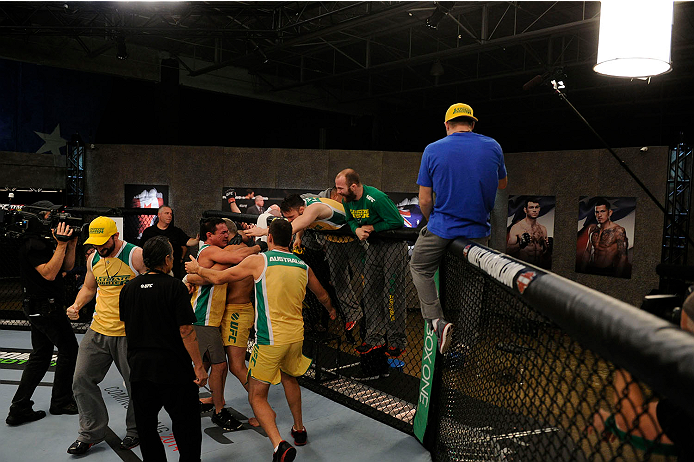 LACHUTE, CANADA - NOVEMBER 11: Team Australia fighter Tyler Manawaroa celebrates with his team after defeating Team Canada fighter Nordine Taleb in their middleweight fight during filming of The Ultimate Fighter Nations television series on November 11,