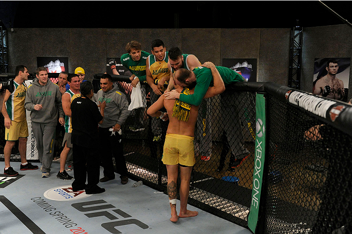 LACHUTE, CANADA - NOVEMBER 11: Team Australia fighter Tyler Manawaroa celebrates with his team after defeating Team Canada fighter Nordine Taleb in their middleweight fight during filming of The Ultimate Fighter Nations television series on November 11,