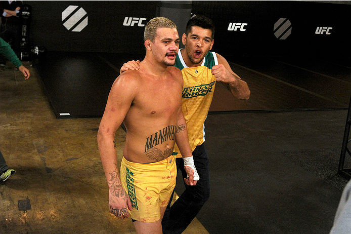 LACHUTE, CANADA - NOVEMBER 11: Team Australia fighter Tyler Manawaroa celebrates with his team after defeating Team Canada fighter Nordine Taleb in their middleweight fight during filming of The Ultimate Fighter Nations television series on November 11,