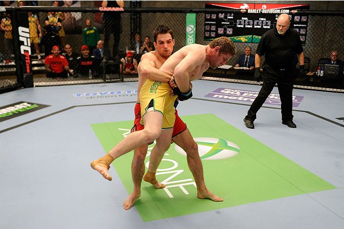 LACHUTE, CANADA - NOVEMBER 17: Team Canada fighter Sheldon Westcott (red shorts) takes down Team Australia fighter Daniel Kelly (yellow shorts) in their middleweight fight during filming of The Ultimate Fighter Nations television series on November 17, 2