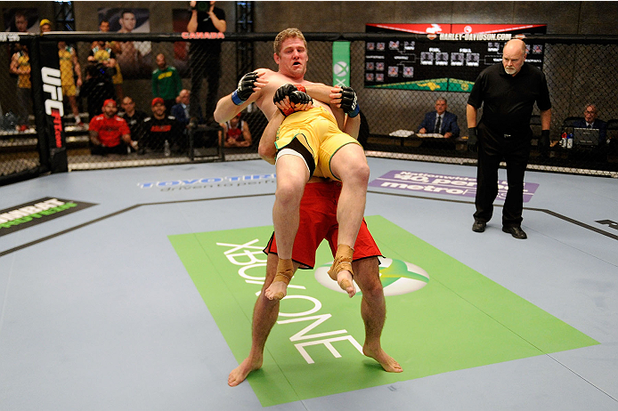 LACHUTE, CANADA - NOVEMBER 17: Team Canada fighter Sheldon Westcott (red shorts) takes down Team Australia fighter Daniel Kelly (yellow shorts) in their middleweight fight during filming of The Ultimate Fighter Nations television series on November 17, 2