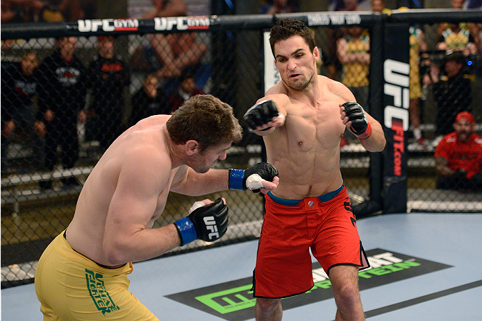 LACHUTE, CANADA - NOVEMBER 17: (R-L) Team Canada fighter Sheldon Westcott punches Team Australia fighter Daniel Kelly in their middleweight fight during filming of The Ultimate Fighter Nations television series on November 17, 2013 in Lachute, Quebec, Ca