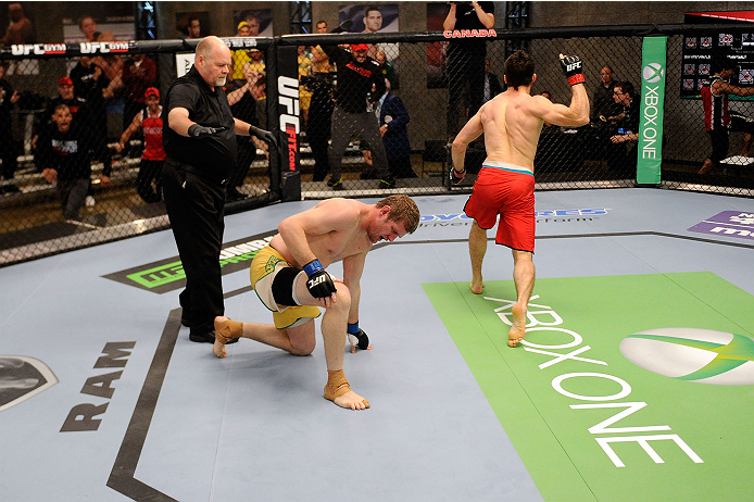 LACHUTE, CANADA - NOVEMBER 17: (R-L) Team Canada fighter Sheldon Westcott celebrates after submitting Team Australia fighter Daniel Kelly in their middleweight fight during filming of The Ultimate Fighter Nations television series on November 17, 2013 in