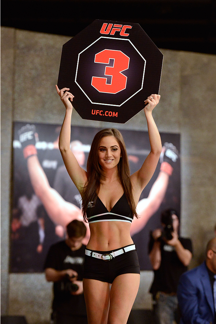 LACHUTE, CANADA - DECEMBER 2: UFC Octagon Girl Stephanie Serfaty signals the start of round three between Team Australia fighter Vik Grujic and Team Canada fighter Luke Harris in their middleweight fight during filming of The Ultimate Fighter Nations tel