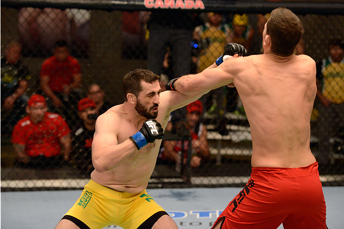 LACHUTE, CANADA - DECEMBER 2: (L-R) Team Australia fighter Vik Grujic punches Team Canada fighter Luke Harris in their middleweight fight during filming of The Ultimate Fighter Nations television series on December 2, 2013 in Lachute, Quebec, Canada. (Ph