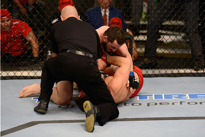 LACHUTE, CANADA - DECEMBER 2: (L-R) Team Australia fighter Vik Grujic is pulled off Team Canada fighter Luke Harris by referee Yves Lavigne in their middleweight fight during filming of The Ultimate Fighter Nations television series on December 2, 2013 i