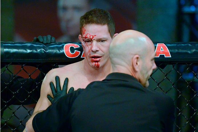 LACHUTE, CANADA - DECEMBER 2: Team Canada fighter Luke Harris is checked out by referee Yves Lavigne after being stopped by Team Australia fighter Vik Grujic in their middleweight fight during filming of The Ultimate Fighter Nations television series on