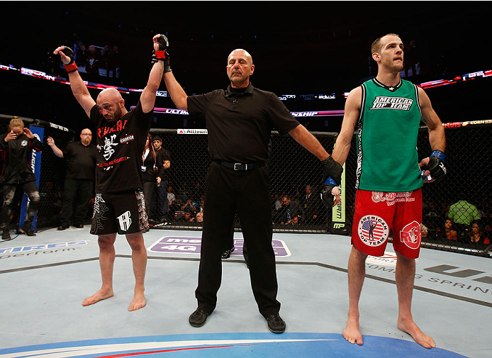 BOSTON, MA - AUGUST 17: Manny Gamburyan (L) reacts after his decision victory over Cole Miller (R) in their UFC featherweight bout at TD Garden on August 17, 2013 in Boston, Massachusetts. (Photo by Josh Hedges/Zuffa LLC/Zuffa LLC via Getty Images)