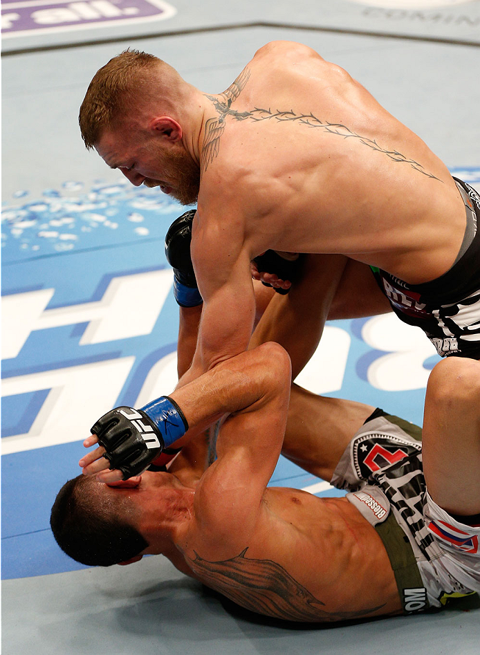 BOSTON, MA - AUGUST 17: (R-L) Conor McGregor punches Max Holloway in their UFC featherweight bout at TD Garden on August 17, 2013 in Boston, Massachusetts. (Photo by Josh Hedges/Zuffa LLC/Zuffa LLC via Getty Images)
