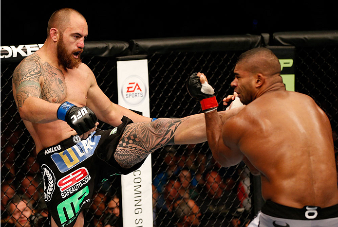 BOSTON, MA - AUGUST 17: (L-R) Travis Browne knocks down Alistair Overeem with a kick in their UFC heavyweight bout at TD Garden on August 17, 2013 in Boston, Massachusetts. (Photo by Josh Hedges/Zuffa LLC/Zuffa LLC via Getty Images)
