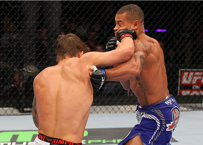 INDIANAPOLIS, IN - AUGUST 28: (L-R) Roger Bowling punches Abel Trujillo in their lightweight fight during the UFC on FOX Sports 1 event at Bankers Life Fieldhouse on August 28, 2013 in Indianapolis, Indiana. (Photo by Ed Mulholland/Zuffa LLC/Zuffa LLC vi