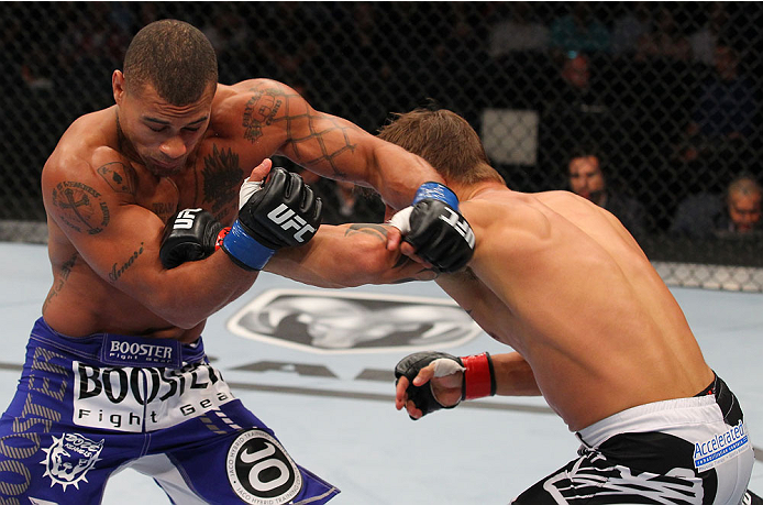INDIANAPOLIS, IN - AUGUST 28: (R-L) Roger Bowling punches Abel Trujillo in their lightweight fight during the UFC on FOX Sports 1 event at Bankers Life Fieldhouse on August 28, 2013 in Indianapolis, Indiana. (Photo by Ed Mulholland/Zuffa LLC/Zuffa LLC vi