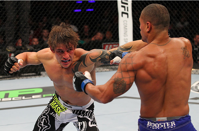 INDIANAPOLIS, IN - AUGUST 28: (L-R) Roger Bowling punches Abel Trujillo in their lightweight fight during the UFC on FOX Sports 1 event at Bankers Life Fieldhouse on August 28, 2013 in Indianapolis, Indiana. (Photo by Ed Mulholland/Zuffa LLC/Zuffa LLC vi