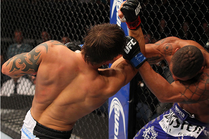 INDIANAPOLIS, IN - AUGUST 28: (L-R) Roger Bowling punches Abel Trujillo in their lightweight fight during the UFC on FOX Sports 1 event at Bankers Life Fieldhouse on August 28, 2013 in Indianapolis, Indiana. (Photo by Ed Mulholland/Zuffa LLC/Zuffa LLC vi