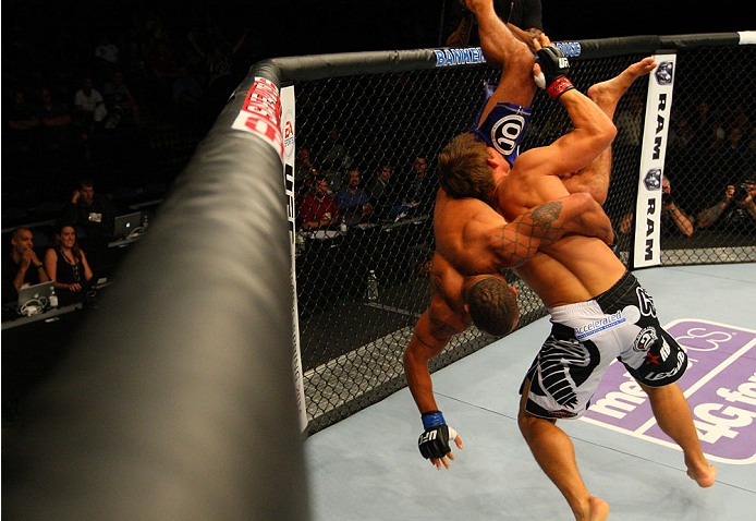 INDIANAPOLIS, IN - AUGUST 28: (R-L) Roger Bowling takes down Abel Trujillo in their lightweight fight during the UFC on FOX Sports 1 event at Bankers Life Fieldhouse on August 28, 2013 in Indianapolis, Indiana. (Photo by Ed Mulholland/Zuffa LLC/Zuffa LLC