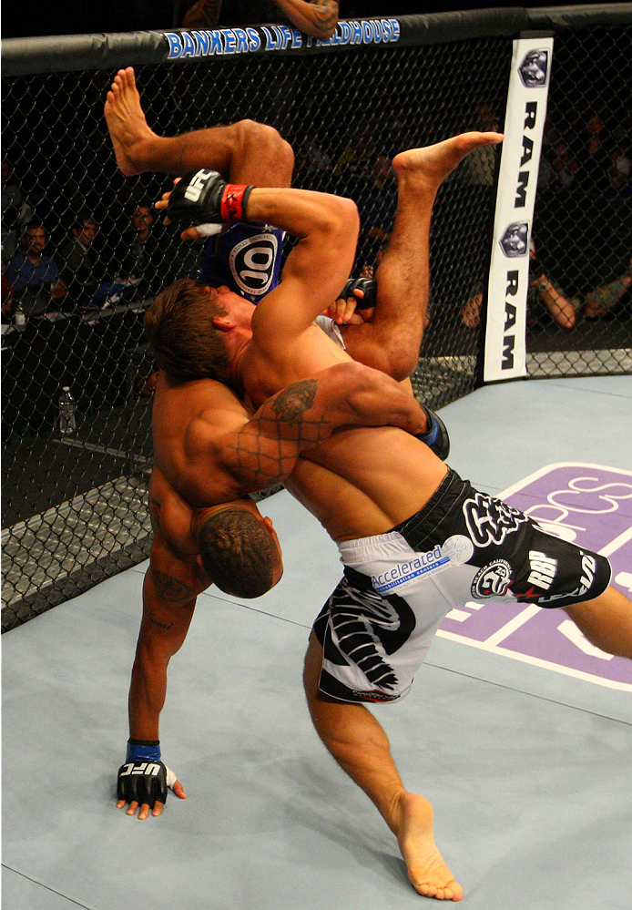 INDIANAPOLIS, IN - AUGUST 28: (R-L) Roger Bowling takes down Abel Trujillo in their lightweight fight during the UFC on FOX Sports 1 event at Bankers Life Fieldhouse on August 28, 2013 in Indianapolis, Indiana. (Photo by Ed Mulholland/Zuffa LLC/Zuffa LLC