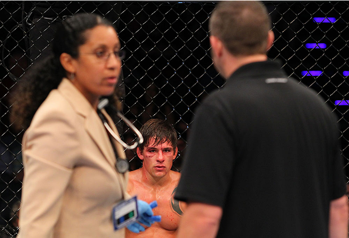 INDIANAPOLIS, IN - AUGUST 28: Roger Bowling looks on as the doctor and referee consult after he suffered an illegal knee against Abel Trujillo in their lightweight fight during the UFC on FOX Sports 1 event at Bankers Life Fieldhouse on August 28, 2013 i