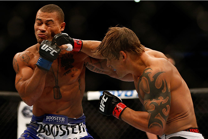 INDIANAPOLIS, IN - AUGUST 28: (R-L) Roger Bowling punches Abel Trujillo in their lightweight fight during the UFC on FOX Sports 1 event at Bankers Life Fieldhouse on August 28, 2013 in Indianapolis, Indiana. (Photo by Josh Hedges/Zuffa LLC/Zuffa LLC via