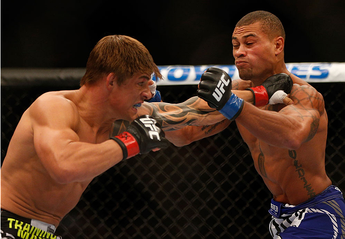 INDIANAPOLIS, IN - AUGUST 28: (L-R) Roger Bowling punches Abel Trujillo in their lightweight fight during the UFC on FOX Sports 1 event at Bankers Life Fieldhouse on August 28, 2013 in Indianapolis, Indiana. (Photo by Josh Hedges/Zuffa LLC/Zuffa LLC via