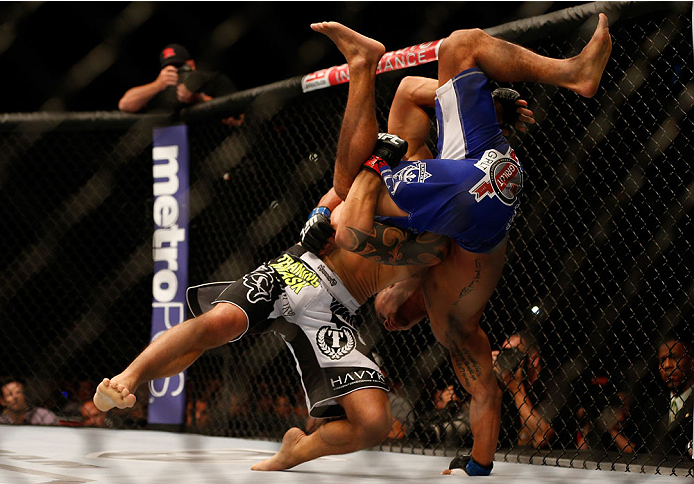 INDIANAPOLIS, IN - AUGUST 28: (L-R) Roger Bowling takes down Abel Trujillo in their lightweight fight during the UFC on FOX Sports 1 event at Bankers Life Fieldhouse on August 28, 2013 in Indianapolis, Indiana. (Photo by Josh Hedges/Zuffa LLC/Zuffa LLC v