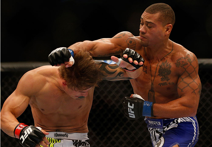 INDIANAPOLIS, IN - AUGUST 28: (R-L) Abel Trujillo punches Roger Bowling in their lightweight fight during the UFC on FOX Sports 1 event at Bankers Life Fieldhouse on August 28, 2013 in Indianapolis, Indiana. (Photo by Josh Hedges/Zuffa LLC/Zuffa LLC via