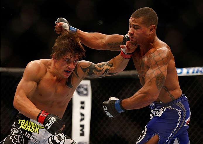 INDIANAPOLIS, IN - AUGUST 28: (L-R) Roger Bowling punches Abel Trujillo in their lightweight fight during the UFC on FOX Sports 1 event at Bankers Life Fieldhouse on August 28, 2013 in Indianapolis, Indiana. (Photo by Josh Hedges/Zuffa LLC/Zuffa LLC via