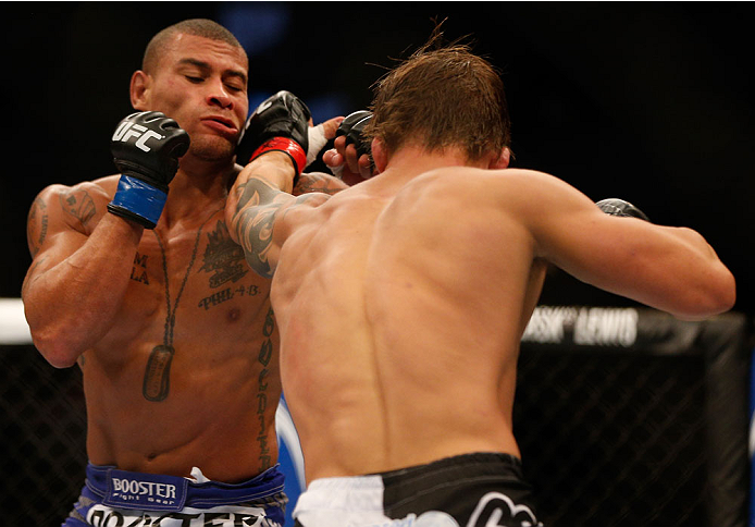INDIANAPOLIS, IN - AUGUST 28: (R-L) Roger Bowling punches Abel Trujillo in their lightweight fight during the UFC on FOX Sports 1 event at Bankers Life Fieldhouse on August 28, 2013 in Indianapolis, Indiana. (Photo by Josh Hedges/Zuffa LLC/Zuffa LLC via