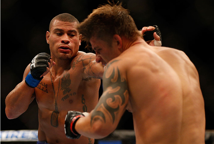 INDIANAPOLIS, IN - AUGUST 28: (L-R) Abel Trujillo punches Roger Bowling in their lightweight fight during the UFC on FOX Sports 1 event at Bankers Life Fieldhouse on August 28, 2013 in Indianapolis, Indiana. (Photo by Josh Hedges/Zuffa LLC/Zuffa LLC via