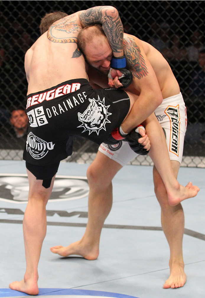 INDIANAPOLIS, IN - AUGUST 28: (R-L) Zak Cummings attempts to take down Benny Alloway in their welterweight fight during the UFC on FOX Sports 1 event at Bankers Life Fieldhouse on August 28, 2013 in Indianapolis, Indiana. (Photo by Ed Mulholland/Zuffa LL