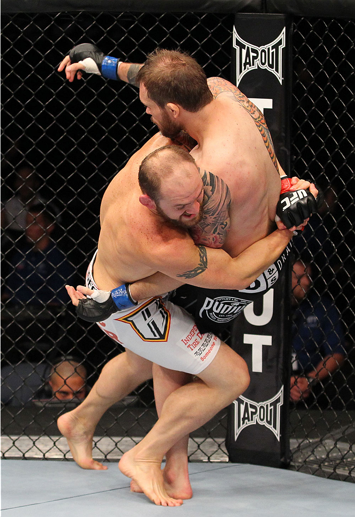 INDIANAPOLIS, IN - AUGUST 28: (L-R) Zak Cummings takes down Benny Alloway in their welterweight fight during the UFC on FOX Sports 1 event at Bankers Life Fieldhouse on August 28, 2013 in Indianapolis, Indiana. (Photo by Ed Mulholland/Zuffa LLC/Zuffa LLC