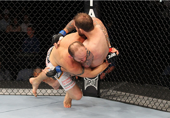 INDIANAPOLIS, IN - AUGUST 28: (L-R) Zak Cummings takes down Benny Alloway in their welterweight fight during the UFC on FOX Sports 1 event at Bankers Life Fieldhouse on August 28, 2013 in Indianapolis, Indiana. (Photo by Ed Mulholland/Zuffa LLC/Zuffa LLC