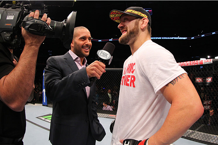 INDIANAPOLIS, IN - AUGUST 28: (R-L) Zak Cummings is interviewed by Jon Anik after his victory over Benny Alloway in their welterweight fight during the UFC on FOX Sports 1 event at Bankers Life Fieldhouse on August 28, 2013 in Indianapolis, Indiana. (Pho