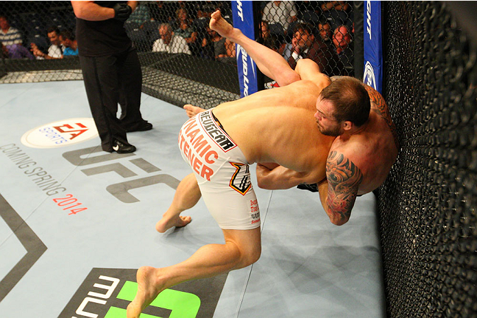 INDIANAPOLIS, IN - AUGUST 28: (L-R) Zak Cummings takes down Benny Alloway in their welterweight fight during the UFC on FOX Sports 1 event at Bankers Life Fieldhouse on August 28, 2013 in Indianapolis, Indiana. (Photo by Ed Mulholland/Zuffa LLC/Zuffa LLC