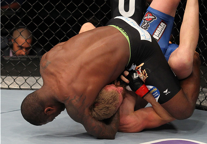 INDIANAPOLIS, IN - AUGUST 28: (L-R) Jason High secures a guillotine choke submission against James Head in their welterweight fight during the UFC on FOX Sports 1 event at Bankers Life Fieldhouse on August 28, 2013 in Indianapolis, Indiana. (Photo by Ed M
