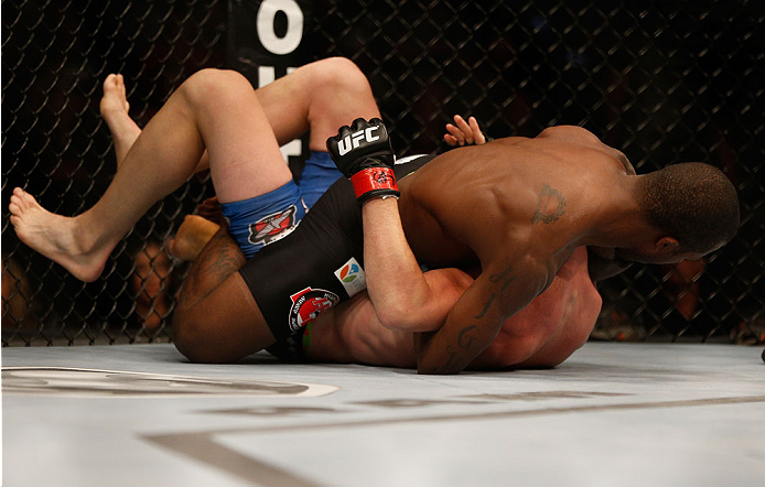 INDIANAPOLIS, IN - AUGUST 28: (R-L) Jason High secures a guillotine choke submission against James Head in their welterweight fight during the UFC on FOX Sports 1 event at Bankers Life Fieldhouse on August 28, 2013 in Indianapolis, Indiana. (Photo by Jos