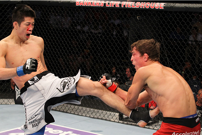INDIANAPOLIS, IN - AUGUST 28: (L-R) Hatsu Hioki kicks Darren Elkins in their featherweight fight during the UFC on FOX Sports 1 event at Bankers Life Fieldhouse on August 28, 2013 in Indianapolis, Indiana. (Photo by Ed Mulholland/Zuffa LLC/Zuffa LLC via