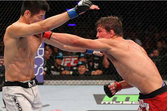 INDIANAPOLIS, IN - AUGUST 28: (R-L) Darren Elkins punches Hatsu Hioki in their featherweight fight during the UFC on FOX Sports 1 event at Bankers Life Fieldhouse on August 28, 2013 in Indianapolis, Indiana. (Photo by Ed Mulholland/Zuffa LLC/Zuffa LLC vi