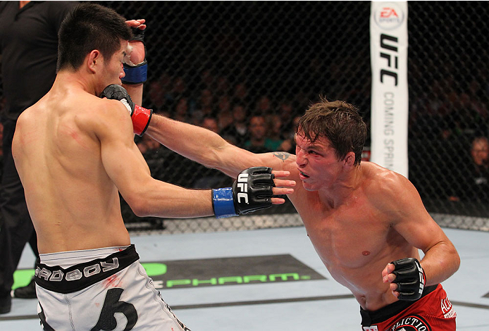 INDIANAPOLIS, IN - AUGUST 28: (R-L) Darren Elkins punches Hatsu Hioki in their featherweight fight during the UFC on FOX Sports 1 event at Bankers Life Fieldhouse on August 28, 2013 in Indianapolis, Indiana. (Photo by Ed Mulholland/Zuffa LLC/Zuffa LLC vi