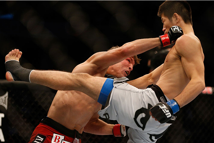 INDIANAPOLIS, IN - AUGUST 28: (L-R) Darren Elkins punches Hatsu Hioki in their featherweight fight during the UFC on FOX Sports 1 event at Bankers Life Fieldhouse on August 28, 2013 in Indianapolis, Indiana. (Photo by Josh Hedges/Zuffa LLC/Zuffa LLC via