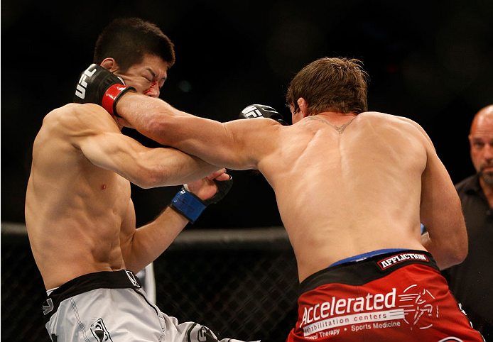 INDIANAPOLIS, IN - AUGUST 28: (R-L) Darren Elkins punches Hatsu Hioki in their featherweight fight during the UFC on FOX Sports 1 event at Bankers Life Fieldhouse on August 28, 2013 in Indianapolis, Indiana. (Photo by Josh Hedges/Zuffa LLC/Zuffa LLC via