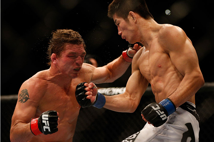 INDIANAPOLIS, IN - AUGUST 28: (R-L) Hatsu Hioki punches Darren Elkins in their featherweight fight during the UFC on FOX Sports 1 event at Bankers Life Fieldhouse on August 28, 2013 in Indianapolis, Indiana. (Photo by Josh Hedges/Zuffa LLC/Zuffa LLC via