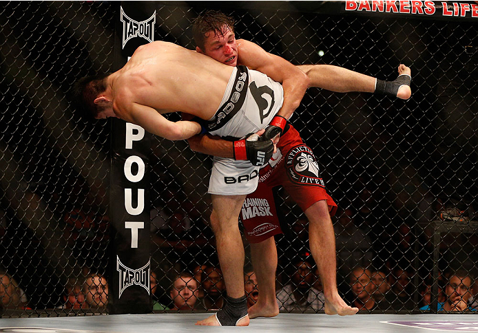 INDIANAPOLIS, IN - AUGUST 28: (R-L) Darren Elkins takes down Hatsu Hioki in their featherweight fight during the UFC on FOX Sports 1 event at Bankers Life Fieldhouse on August 28, 2013 in Indianapolis, Indiana. (Photo by Josh Hedges/Zuffa LLC/Zuffa LLC v