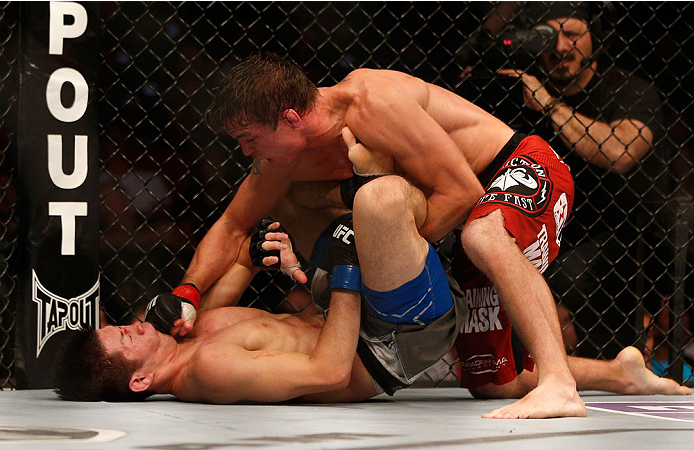 INDIANAPOLIS, IN - AUGUST 28: (R-L) Darren Elkins punches Hatsu Hioki in their featherweight fight during the UFC on FOX Sports 1 event at Bankers Life Fieldhouse on August 28, 2013 in Indianapolis, Indiana. (Photo by Josh Hedges/Zuffa LLC/Zuffa LLC via